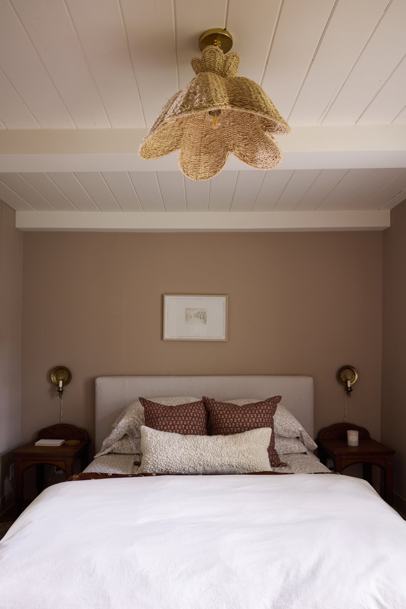 Solie pendant in a bedroom, showing the fixture in proportion to the bed and ceiling